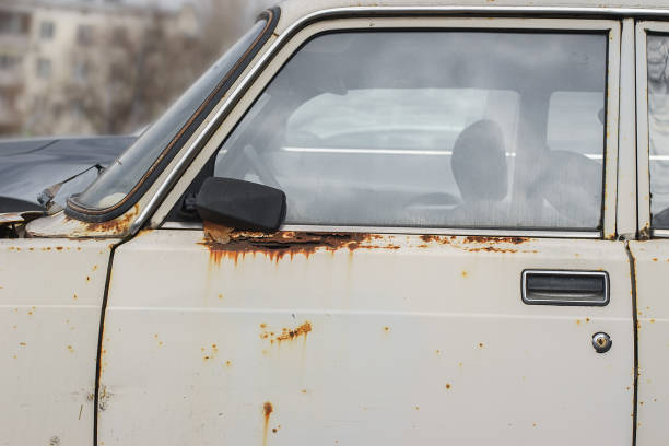 istock Old rusty and dusty car parked in the street. 1479771612