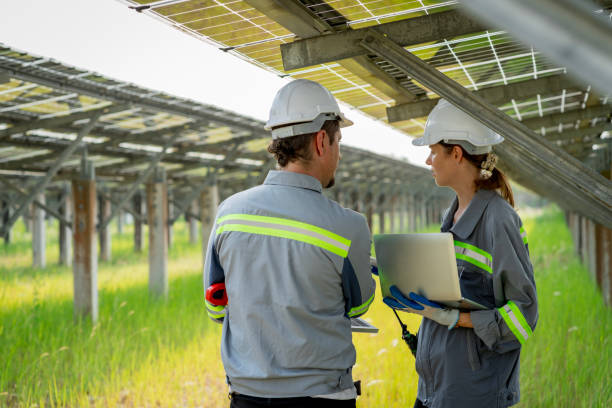 istock Electrical engineer on solar farm with large structure Check maintain rehearse damaged parts from use in order to produce electricity with maximum efficiency throughout its service life professionally 1479775610