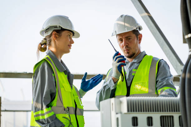 istock Electrical engineer on solar farm with large structure Check maintain rehearse damaged parts from use in order to produce electricity with maximum efficiency throughout its service life professionally 1479775954