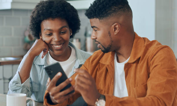 istock Young happy couple having fun using smartphone at home 1479777923