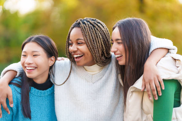 istock Multiethnic friends embracing while smiling in the park 1479778265