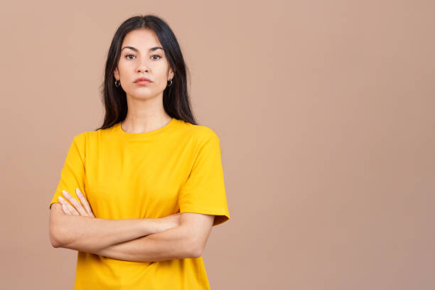 Caucasian woman crossing the arms with an angry expression Caucasian woman crossing the arms with an angry expression in studio with brown background gesturing stock pictures, royalty-free photos & images