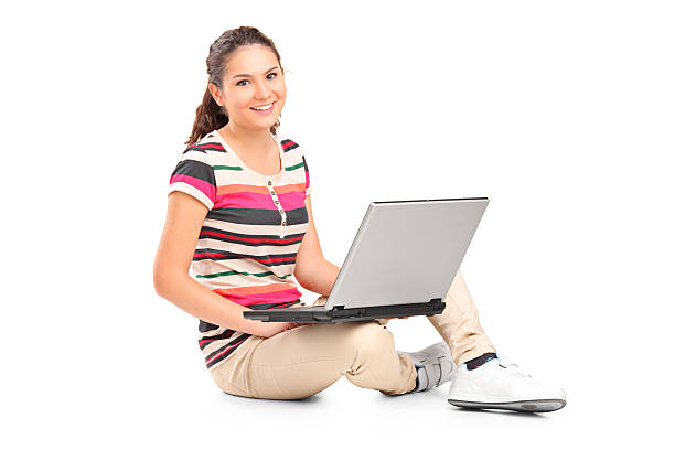 istock Smiling teenager doing her homework on a laptop 147978007