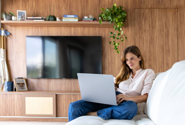 istock Happy woman working at home on her laptop 1479782269