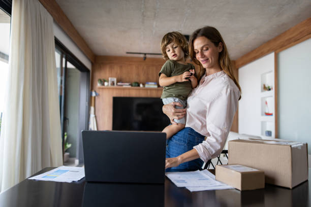 Mother running her e-commerce business from home while taking her of her son
