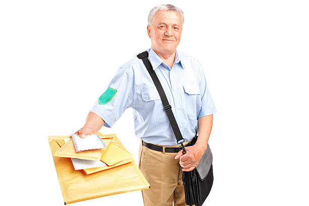 A smiling mature postman delivering letters isolated against white background