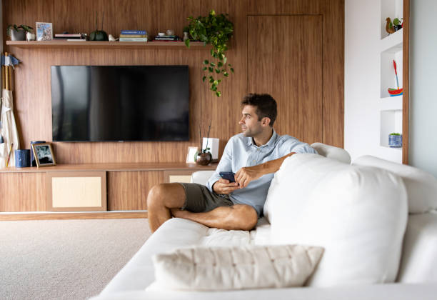 istock Man at home texting on his cell phone and looking distracted 1479782556