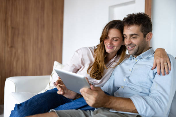 istock Couple at home shopping online using a tablet 1479782573
