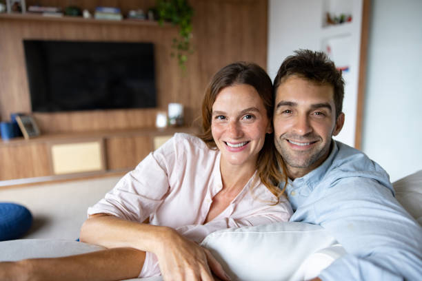istock Loving couple relaxing at home looking happy 1479782786