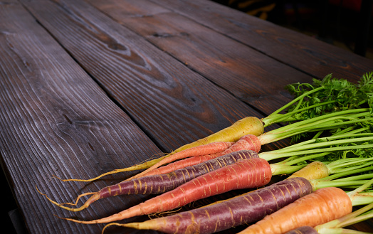 Color carrot with leaves at organic greengrocer's shop. stock photo.