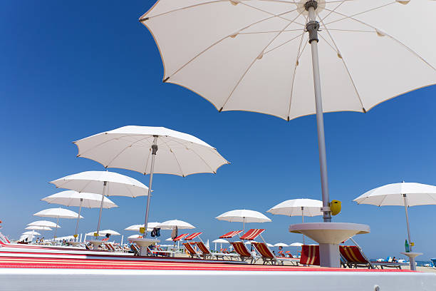 white beach umbrellas in Rimini - Emilia Romagna, Italy stock photo