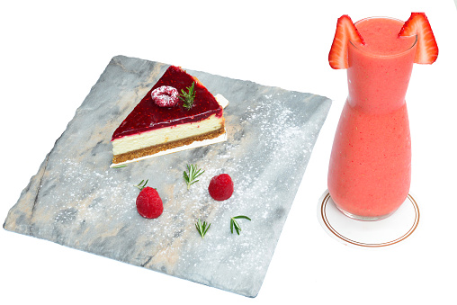 Blueberry cheesecake with strawberry juice on a white background