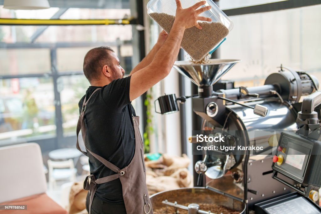 Pouring Raw Coffee Beans to Roasting Machine Coffee Roasting Machine Coffee Roaster Stock Photo
