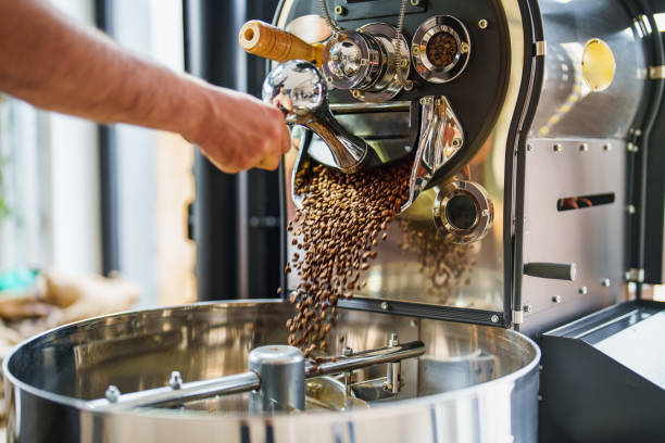Pouring Coffee Beans to Cooler from Coffee Roasting Machine stock photo