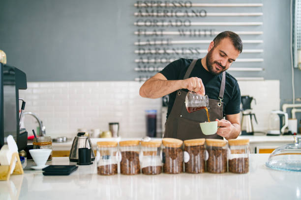 Barista  pouring coffee to cup, Coffee Shop Small Business stock photo
