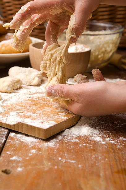istock Detail of hands kneading dough 147979352