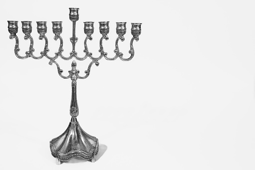 Beautiful silver hanukkah menorah. Ancient ritual candle menorah on a white background. Jewish holiday banner with copy space, horizontal