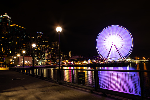 Seattle Washington Skyline at night, City Lights Reflecting on Pacific Ocean, The Seattle Great Wheel Lit Up, Long Exposure, Pier 69