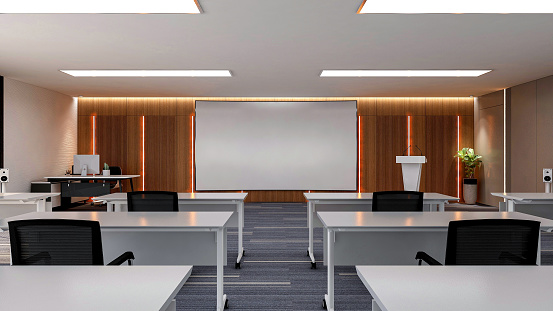 Interior of large modern office training room with large curved monitor screen for presentation and  ceiling TV monitors, 3D rendering