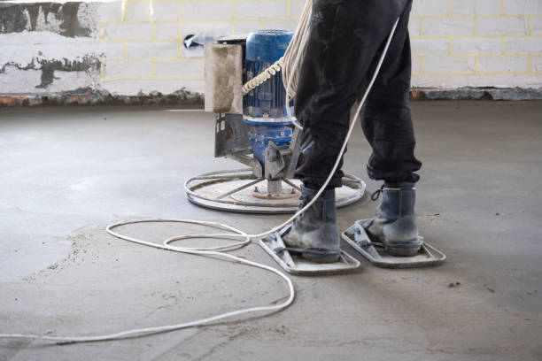 istock Ramming and grinding of semi-dry floor screed by a machine with a rotating disk for leveling. Construction of a concrete floor in the house, a master with special equipment. 1479796537