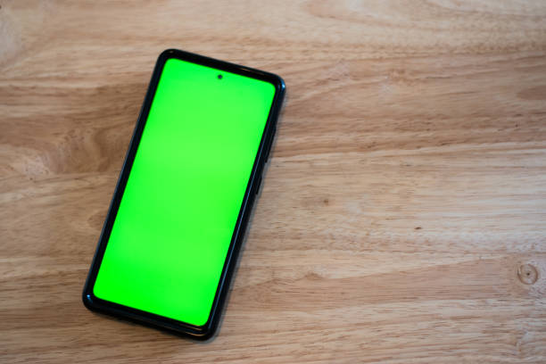 istock Cell phone in a table with green chroma screen 1479797930