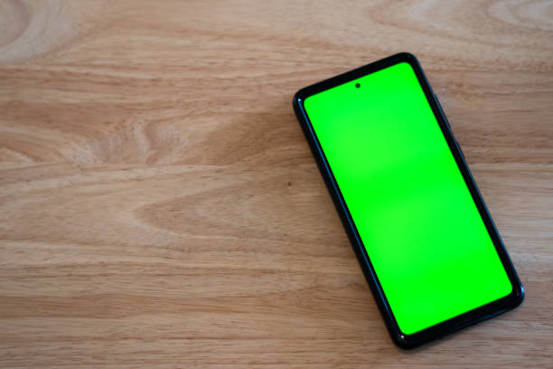 istock Cell phone in a table with green chroma screen 1479798277