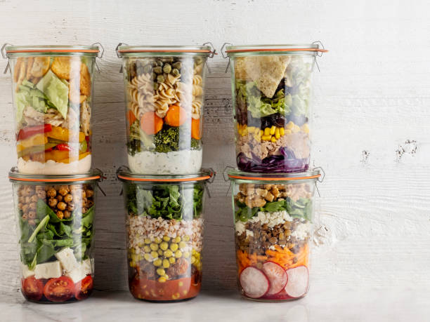 Salad in glass jar, Glass jars with layering various salads for healthy lunch, Salad stock photo