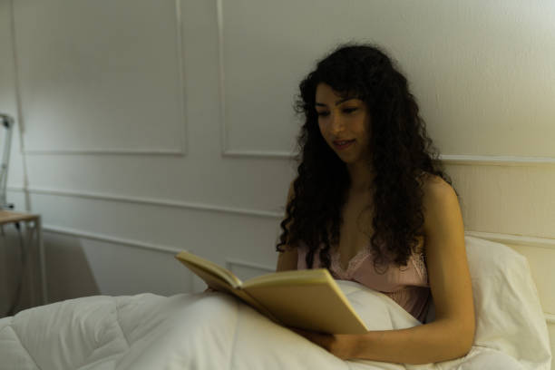 istock Gorgeous woman reading a book before sleeping 1479803992