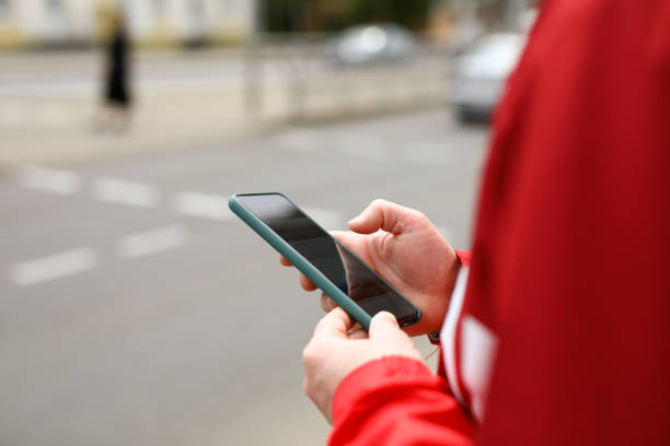 istock Man stands at crossroads with phone in his hands 1479807597