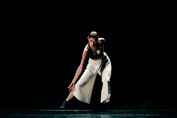 istock Young girl performing contemporary dance on dark stage. 1479807977