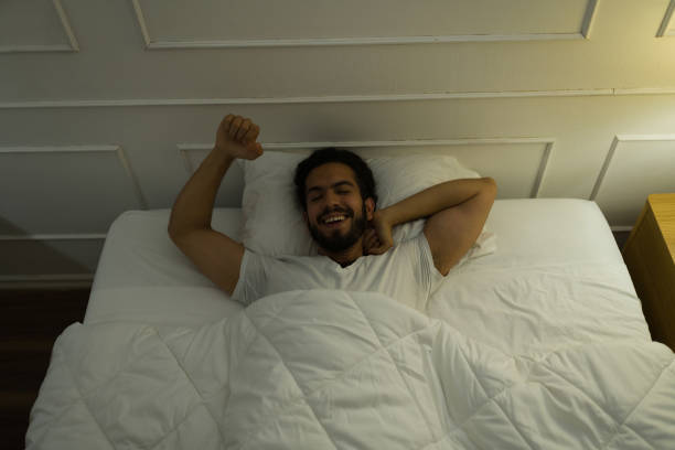 istock Smiling young man waking up well rested 1479809246