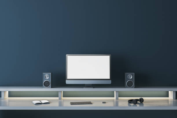 istock Contemporary dark blue designer workspace with empty mock up computer screen, loud speakers and other items. 3D Rendering. 1479810937