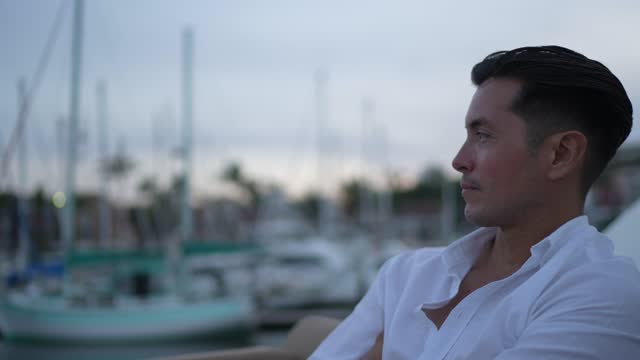 Young man looking away on a yacht