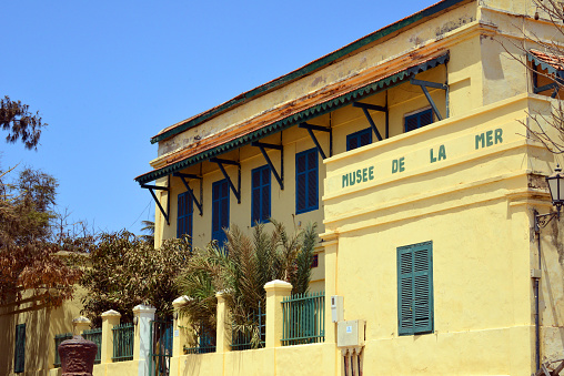 Island of Gorée, Dakar, Senegal: pastel façade with shade of the 18th century building of the French East India Company, now hosting the Maritime Museum, run by the Fundamental Institute of Black Africa (IFAN), Government square - Unesco world heritage site.
