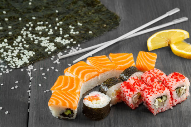 istock sushi and rolls with salmon on a wooden board 1479822144
