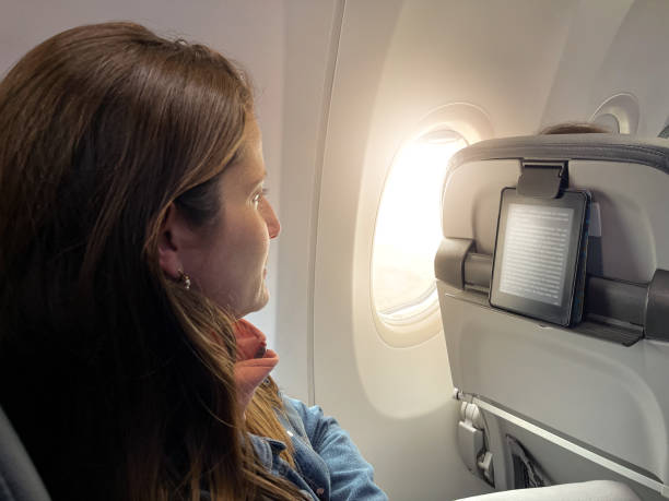 istock Relaxed woman reading an ebook during a flight 1479823668
