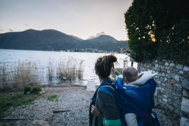istock Mother and infant explore lakeshore together 1479823993