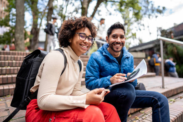 istock Portrait of young university students using mobile phone while study on stair in the city 1479824069