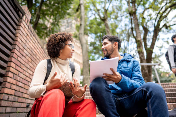 Young university students studying on stair outdoors