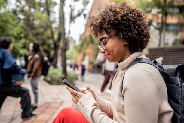 istock Young university student using mobile phone outdoors 1479824252