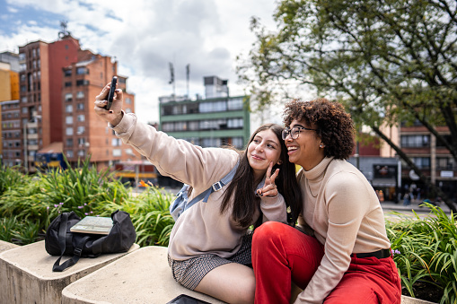 Young university students taking a selfie outdoors