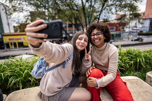 Young university students taking a selfie outdoors