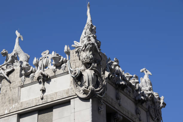 Ornate Stone Carving of Crowned Figure with Floral Relief on Historic Building