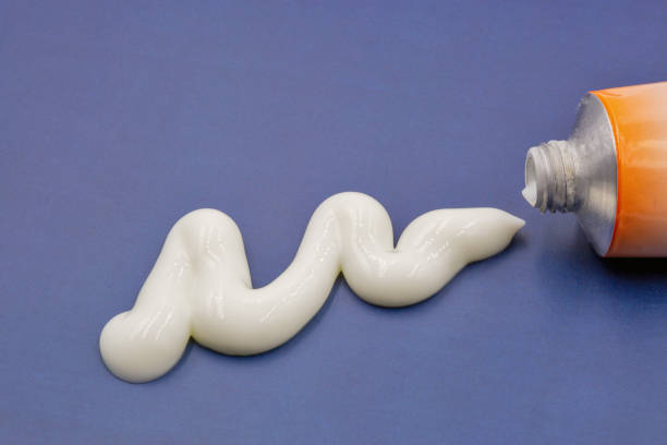 istock White paste squeezed out of a tube closeup on blue 1479833621
