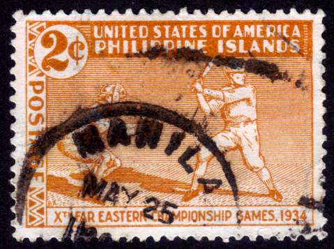 United States of America (Philippine islands) - CIRCA 1935: a stamp printed in United States of America, shows players in baseball, to commemorate the Tenth Far Eastern Championship Games, a sort of regional olympics, history of Baseball, circa 1935