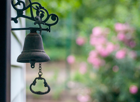 A metal service ringing bell in retro style that placed on the receiption desk. Object photo. Selective focus.