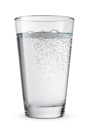 Glass of mineral sparkling water isolated on white background.