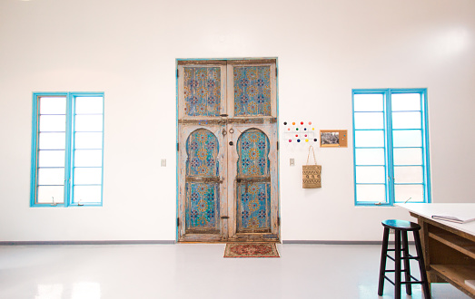 Work Studio with Antique Large Blue Moroccan Doors. Shot inside a home in Santa Fe, NM.