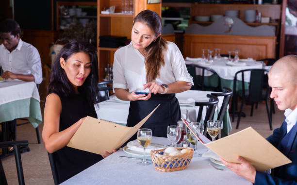 istock Couple making order with hospitable waitress in restaurant 1479854574