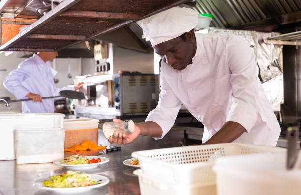 istock Experienced aframerican chef working in professional kitchen of restaurant 1479854809